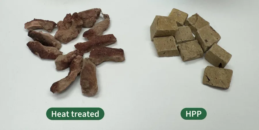 Two piles of freeze-dried beef liver treats side by side: heat treated pieces keep a natural steak-like texture, while HPP pieces are uniform pressed blocks