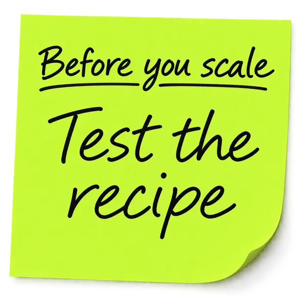 A handwritten sticky note reading before you scale, test the recipe first